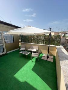 a patio with an umbrella and a table and chairs at Saint Peter Vatican City confortable Apartament Stellasia casa vacanza in Rome