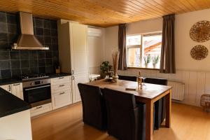 a kitchen with a island in the middle of a room at Gezellig ruim landelijk huisje aan het water in Spijkenisse