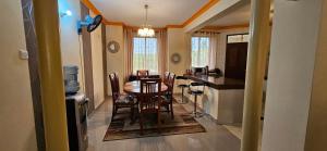 a kitchen and dining room with a table and chairs at Betty Homes in Mombasa