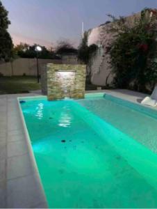 a swimming pool with green water in a yard at CASA CUTI in Reconquista