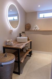 a bathroom with a sink and a mirror at Gezellig ruim landelijk huisje aan het water in Spijkenisse