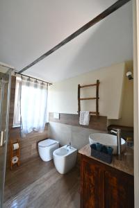 a bathroom with two sinks and two toilets at CASCINA BINELLO in Murazzano