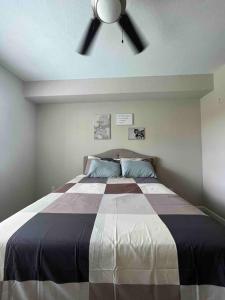 a bedroom with a bed with a ceiling fan at Blooming Journey in Tampa Bay! in Tampa