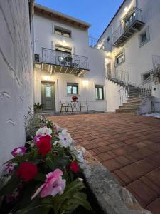 a house with red and white flowers in front of it at Vespista Boutique in Skiathos Town