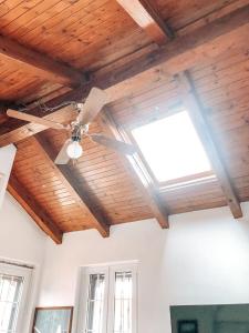 a ceiling fan in a room with a window at La Villa di Bambi in Vanzago