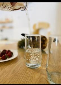 a glass of water is sitting on a table at Fortezzino in Rethymno