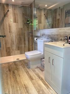 a bathroom with a toilet and a sink and a shower at Glamping with a twist in Charlton