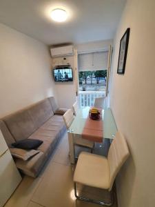 a living room with a couch and a table at Apartman Mila in Split +3 photos