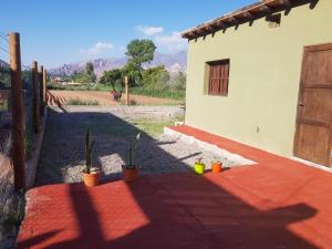 a shadow of a house with potted plants and a door at Casa de alquiler - La Soñada de Tilcara in Tilcara