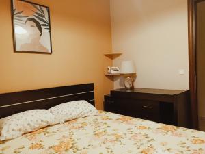 sypialnia z łóżkiem i biurkiem z lampką w obiekcie New Village apartment w Chios