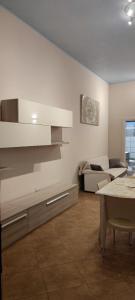 a kitchen and living room with a table and a couch at Residence Salento in Palmariggi