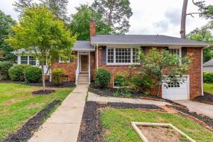 una casa de ladrillo con un árbol en el patio delantero en Renovated House In Buena Vista en Winston-Salem