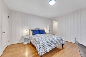 a bedroom with a bed with blue pillows on it at Renovated House In Buena Vista in Winston-Salem
