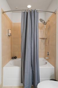 a bathroom with a shower curtain next to a tub at Packhouse 3 in Houston