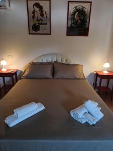 a bedroom with a bed with two towels on it at Profumo di Ostia Antica in Ostia Antica