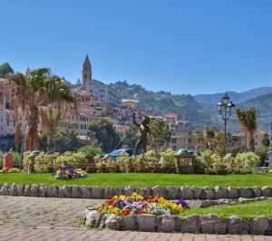 a statue of a woman in a park with flowers at CASA FRONTE MARE in Ventimiglia
