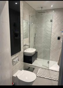 a bathroom with a shower and a toilet and a sink at Private Double bedroom in Thringstone