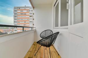 a bench on a balcony with a view of a building at CityStay full brand new appartement 3 bedrooms 5min to Paris in Bagnolet