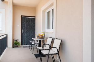 a dining room with a table and chairs and a window at House Bany in Skradin