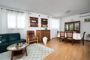 a living room with a green couch and a table at House Bany in Skradin