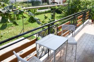 a white table and chairs on a balcony at STUDIO GREENHOUSE in Tolmin