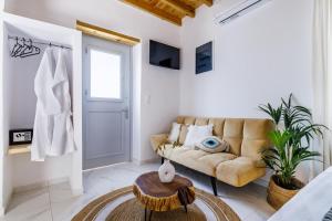 a living room with a couch and a table at Traditional House in Skopelos Town