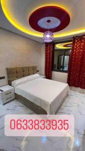 um quarto com uma cama e um lustre em Selouane em Nador