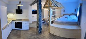 a room with a bed and a kitchen with a desk at Mama Mia Apartments in Radovljica