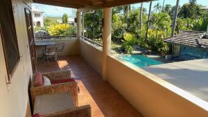 a balcony with a view of a swimming pool at Luxury in Wailoaloa in Nadi