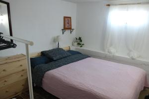 A bed or beds in a room at Half wooden rural apartment
