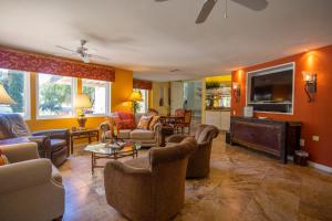 a living room with couches and chairs and a tv at Mountainview Escape in Borrego Springs
