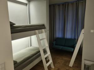 a room with two bunk beds and a chair at Hotellos in Copenhagen