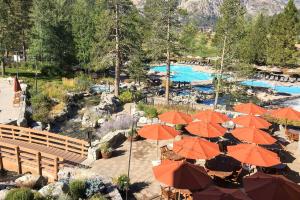 a resort with orange umbrellas and a swimming pool at Resort at Everline Resort & Spa #560 in Olympic Valley