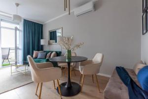 a living room with a table and chairs and a couch at SMARAGD-Emerald in Veszprém