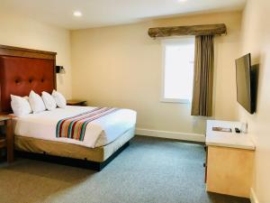 a hotel room with a bed and a window at Bluff Dwellings Resort in Bluff