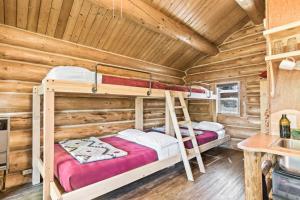 two bunk beds in a log cabin bedroom at Pink Salmon in Soldotna
