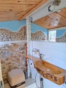 a bathroom in a tiny house with a sink at Paradise kosirina in Murter