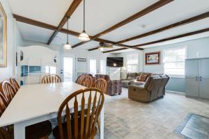 a kitchen and living room with a table and chairs at Swimmin' Hole in Bonneau