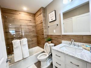 a bathroom with a toilet and a sink and a mirror at 408 Modern styles apartment in center city of Philly in Philadelphia