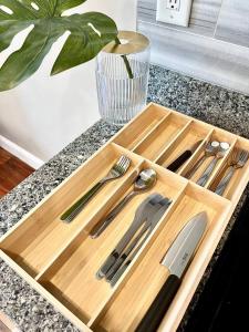 a wooden cutting board with utensils on a counter at 408 Modern styles apartment in center city of Philly in Philadelphia