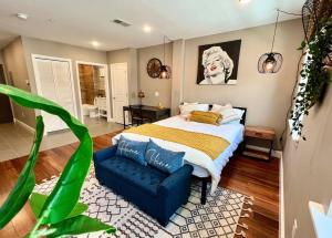 a bedroom with a large bed and a blue couch at 408 Modern styles apartment in center city of Philly in Philadelphia