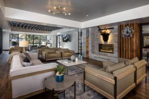a living room with couches and a fireplace at Gravity Haus Vail in Vail