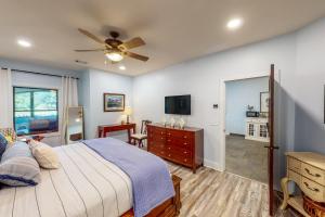 a bedroom with a bed and a flat screen tv at Abruzzi - Villa A in Eatonton 
