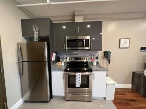 a kitchen with a stainless steel refrigerator and a stove at 302 Comfy Cabin 1BD with city view in Center city in Philadelphia