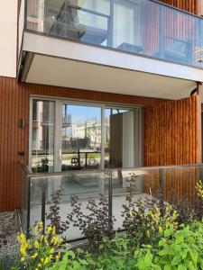 a house with a glass balcony with a patio at Leilighet i Trondheim in Trondheim