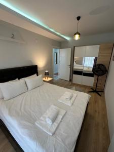 ein Schlafzimmer mit einem weißen Bett mit zwei Handtüchern darauf in der Unterkunft Toya in Antalya