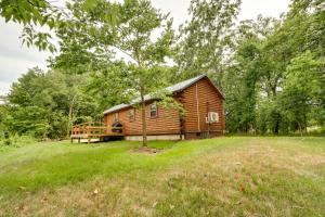 a log cabin in the middle of a field at Florence Cabin with On-Site Creek! in Florence