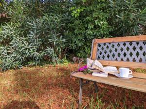 a bench with a book and a cup of coffee and a book at Ars Amici Hotel in Punta del Este