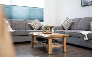 a living room with a couch and a coffee table at Mountain Dreams - Revelstoke Home Near RMR in Revelstoke