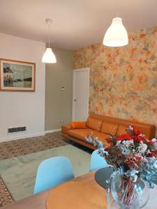 a living room with a couch and a table at Art flat in center near to sea in Blanes